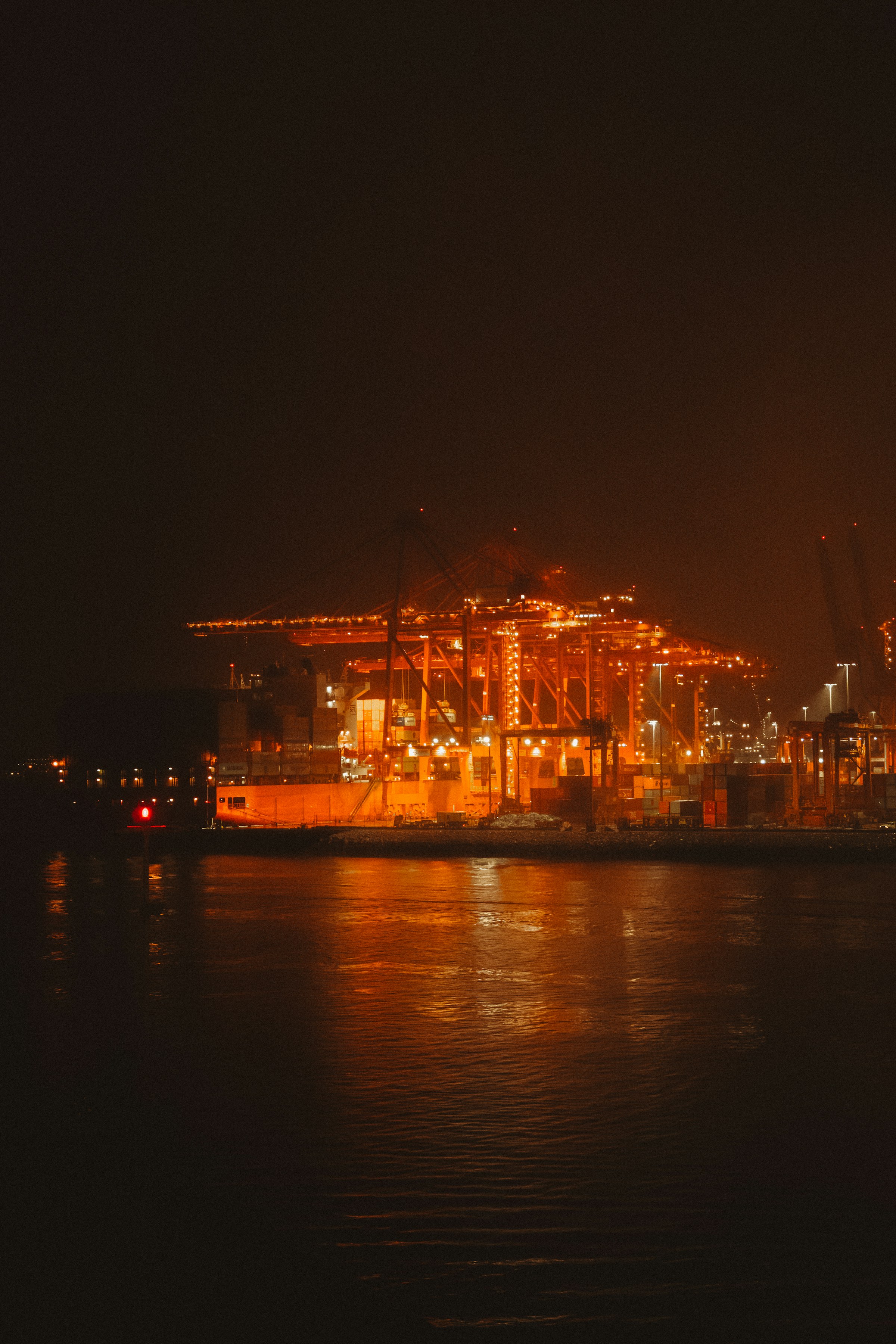 Industrial port cranes illuminated at night